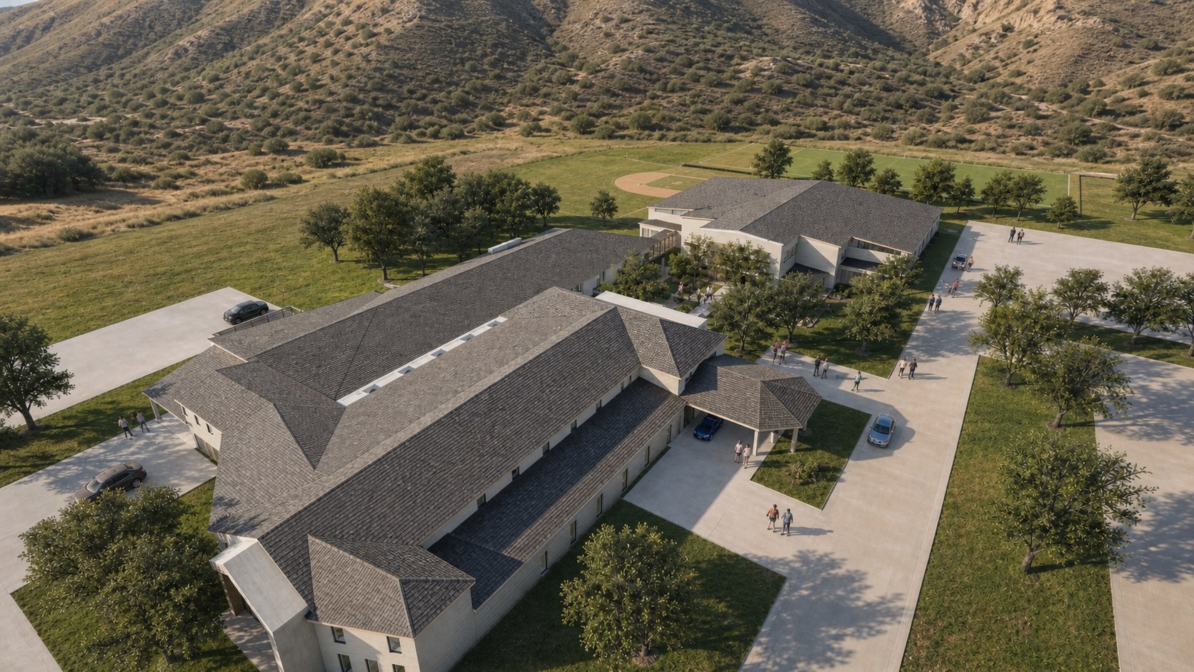 Conceptual aerial rendering of the planned site with buildings, courtyard, ball field and parking
